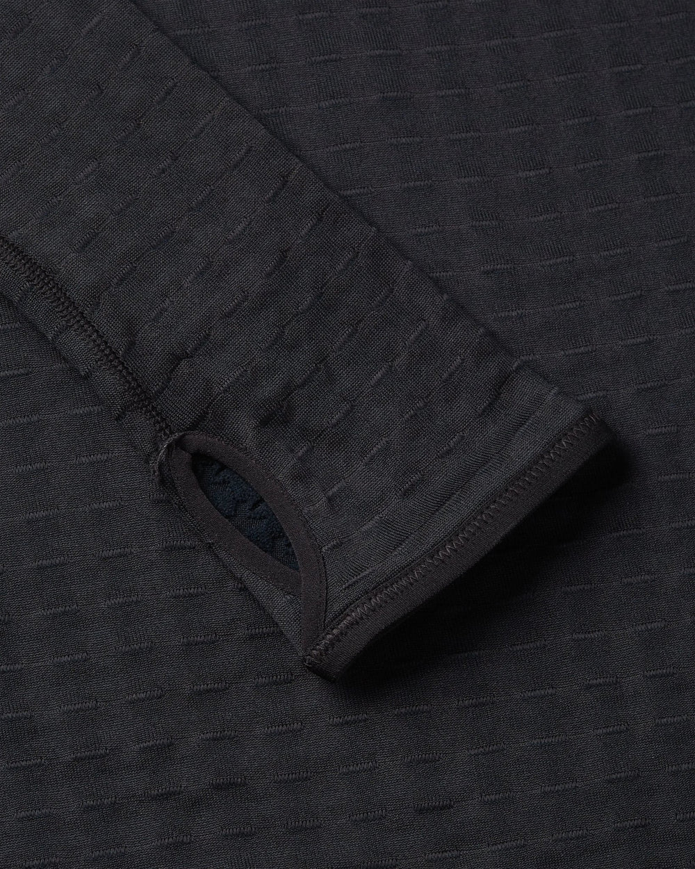 Thumbhole cuff detail on the black Nike x Patta Running Team half-zip longsleeve.