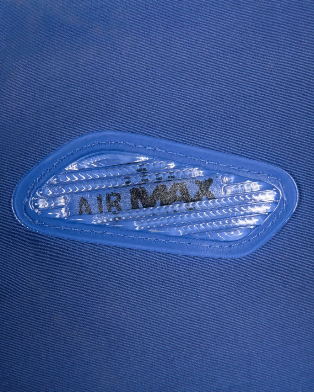 Lenticular Air Max bubble trim detail on the sapphire blue Patta x Nike NRG Track Jacket.
